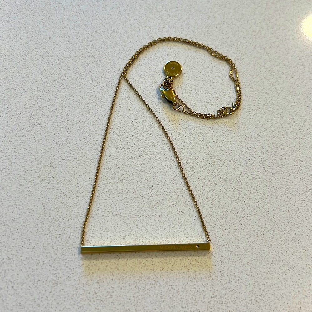 Michael Kors logo gold tone bar pendant necklace